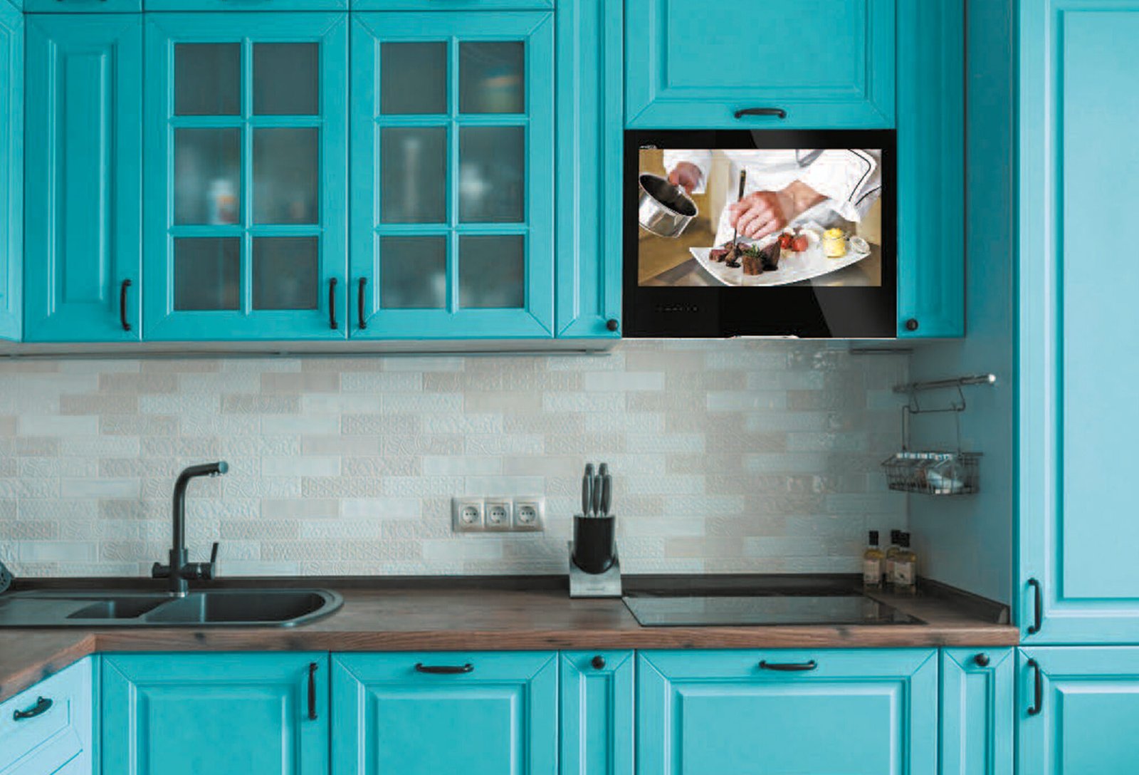 A kitchen cabinet television installed in a modern kitchen